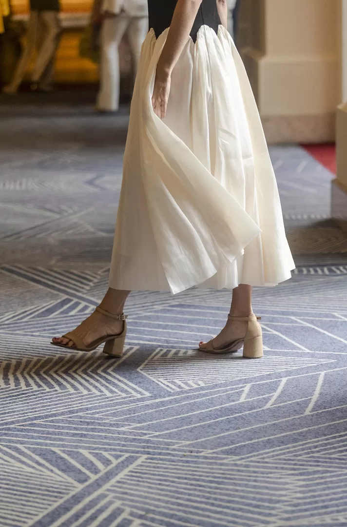 Vestido bicolor blanco con negro de corte maxi-midi, con corset liso sin mangas y falda amplia con ondas estructuradas. Una silueta escultural y elegante que fusiona lo clásico con lo moderno.